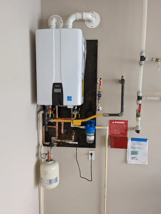 Professional plumber installing copper piping in a Alpine home